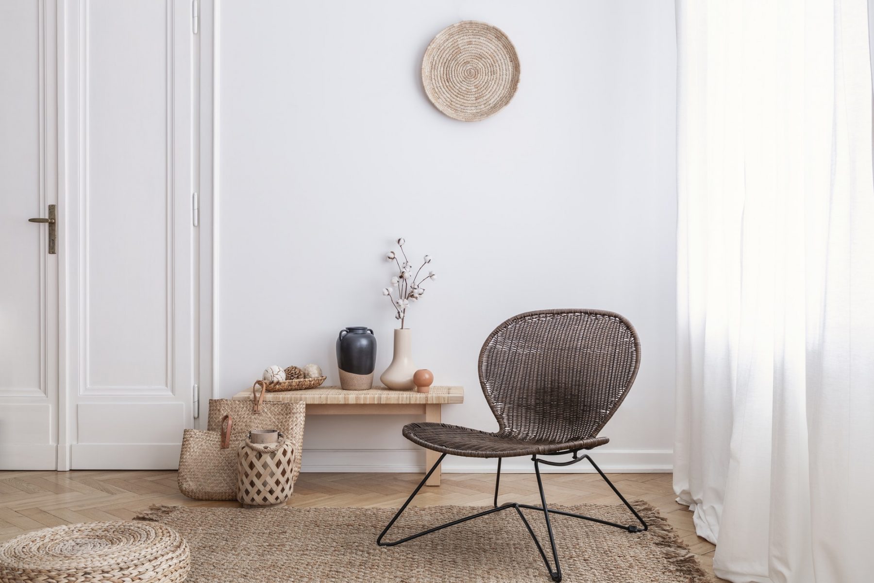 modern-armchair-and-pouf-on-brown-carpet-in-white-apartment-inte.jpg